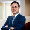 Provost Mandel Portrait in Suit smiling with arms crossed